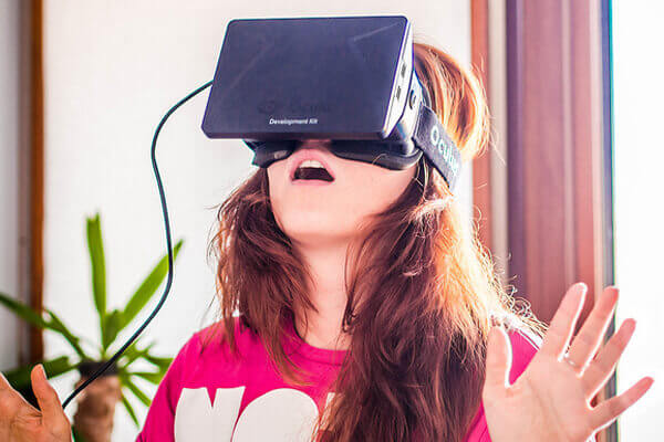 A woman wears the virtual reality headset Oculus Rift.