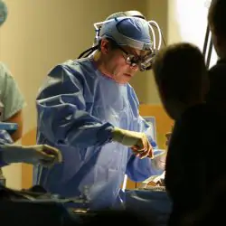 A doctor performs surgery