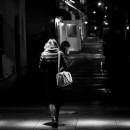 A lady walking in a dark street