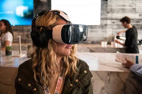 A young woman wears a virtual reality headset.