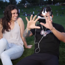 A man watches VR porn next to a woman.
