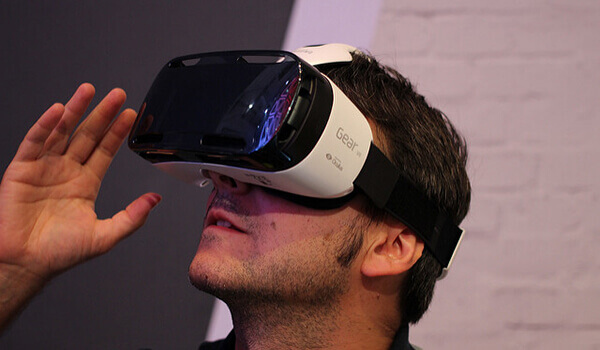 A man wears a Samsung Gear VR headset. 