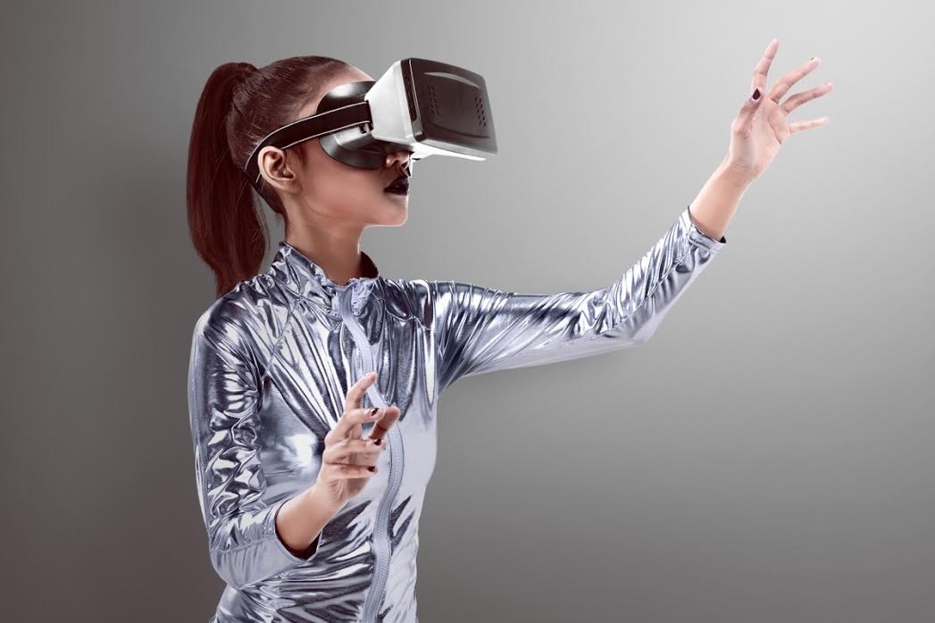 A woman wears a virtual reality headset. 