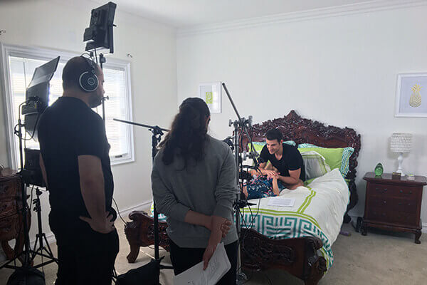 A wide shot a cameras filming a VR adult therapy scene in a bedroom. 