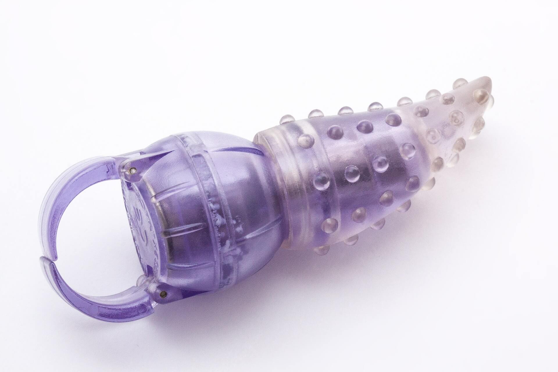 A purple sex toy with a loop and bumps.