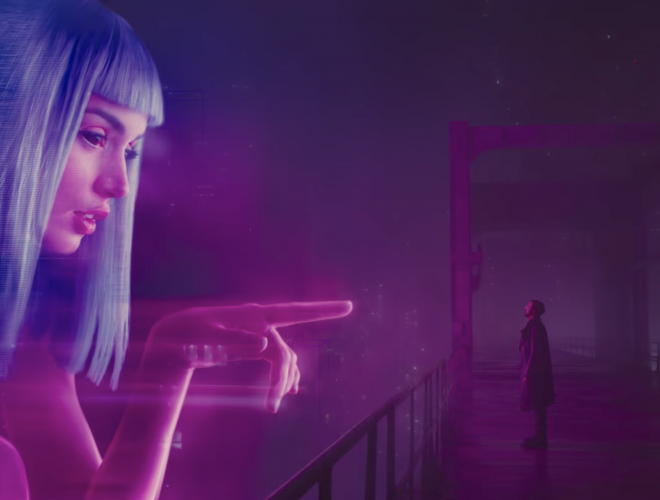 AI companion Joi reaches out to the character K from a billboard ad in the movie Blade Runner 2049.