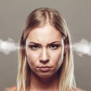 A blonde woman looks annoyed and has steam coming out of her ears.