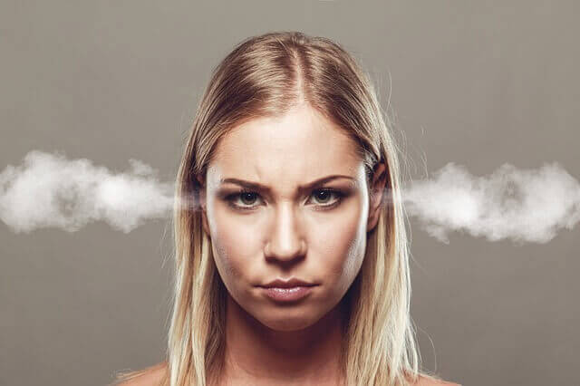 A blonde woman looks annoyed and has steam coming out of her ears.
