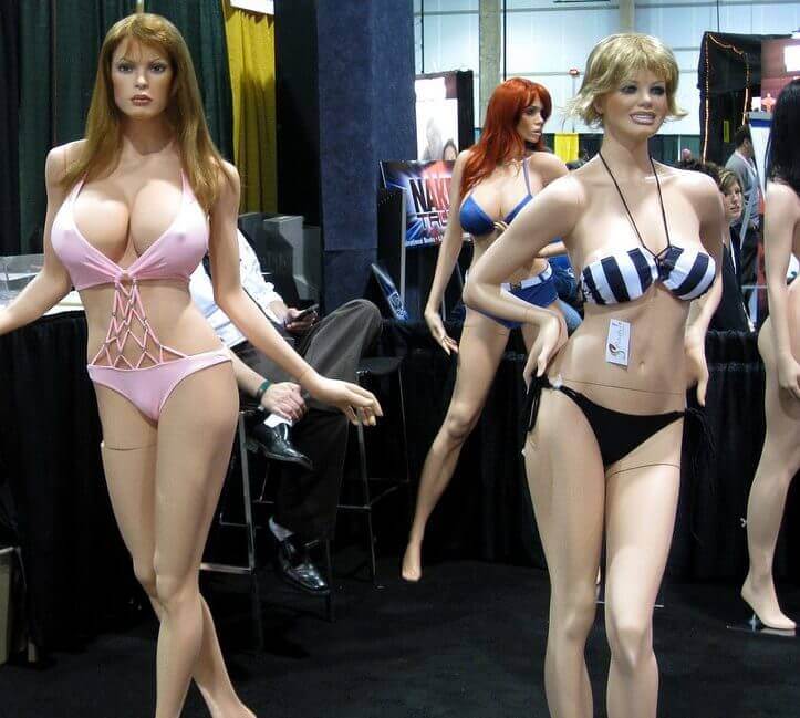 Sex stands are posed standing up while wearing skimpy outfits.