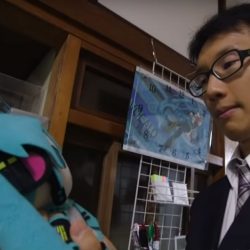 Japanese man holds a stuffed animal versions of his hologram wife.
