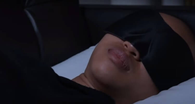 Screenshot of women blindfolded and sleeping