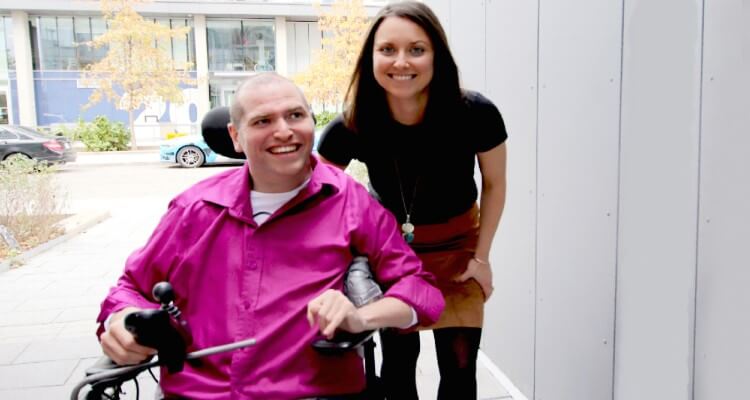 Andrew Gurza in a wheelchair next to sister Heather Morrison 