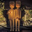 Two humanoid-looking lamps show light bulbs to represent breasts and the genital area.