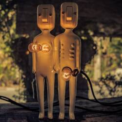 Two humanoid-looking lamps show light bulbs to represent breasts and the genital area.