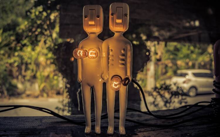 Two humanoid-looking lamps show light bulbs to represent breasts and the genital area.