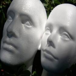 Screenshot of Styrofoam Faces of Male and Female In the Garden