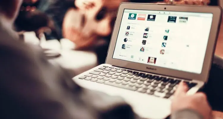 Screenshot of a person on his laptop, in a cafe, accessing internet