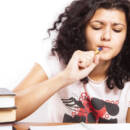 Woman studies with textbooks and notebook