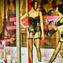 2 mannequin in lingerie displaying sex toys in window shopping area of a store