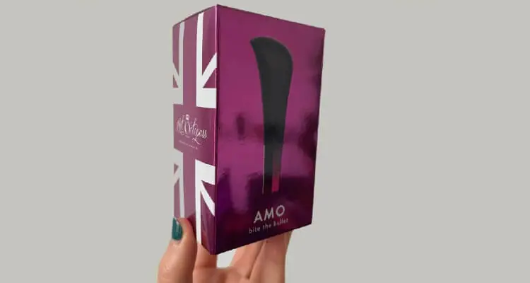 Picture of femal hand holding AMO Hot Octopuss bullet vibrator packet
