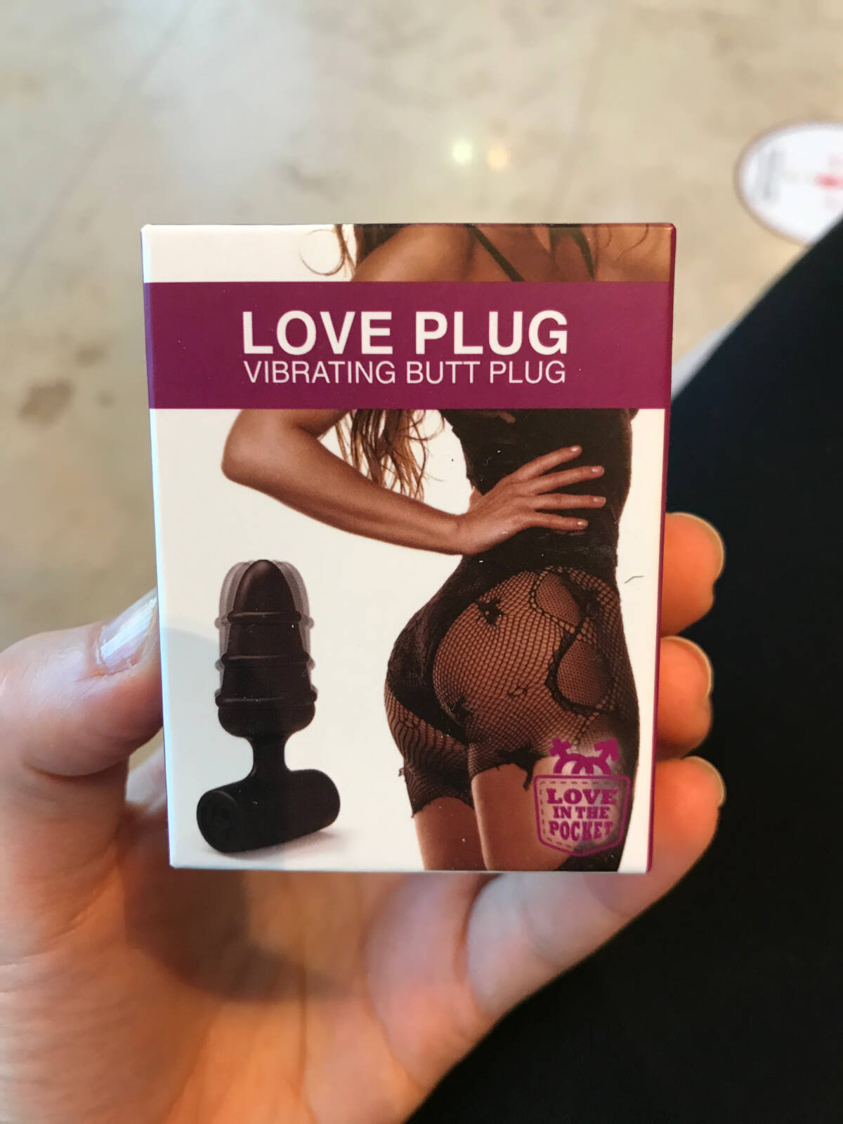 Image of a women holding buttplug box