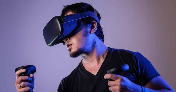 Man wearing vr head gear and haptic controllers.