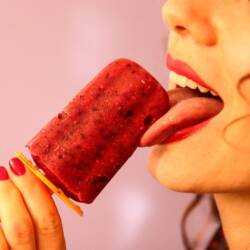 woman licking popsicle