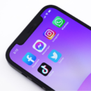 Social media apps on purple smarphone background