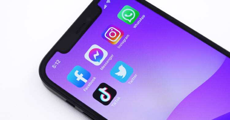 Social media apps on purple smarphone background